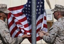 U.s. Marines Lower Their Flag During A Handover Ceremony, As The Last U.s. Marines Unit And British Combat Troops End Their Afghan Operations, In Helmand