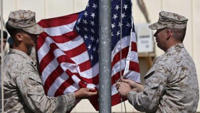 U.s. Marines Lower Their Flag During A Handover Ceremony, As The Last U.s. Marines Unit And British Combat Troops End Their Afghan Operations, In Helmand