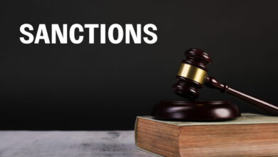 Judge Gavel And Law Books With Sanctions Text