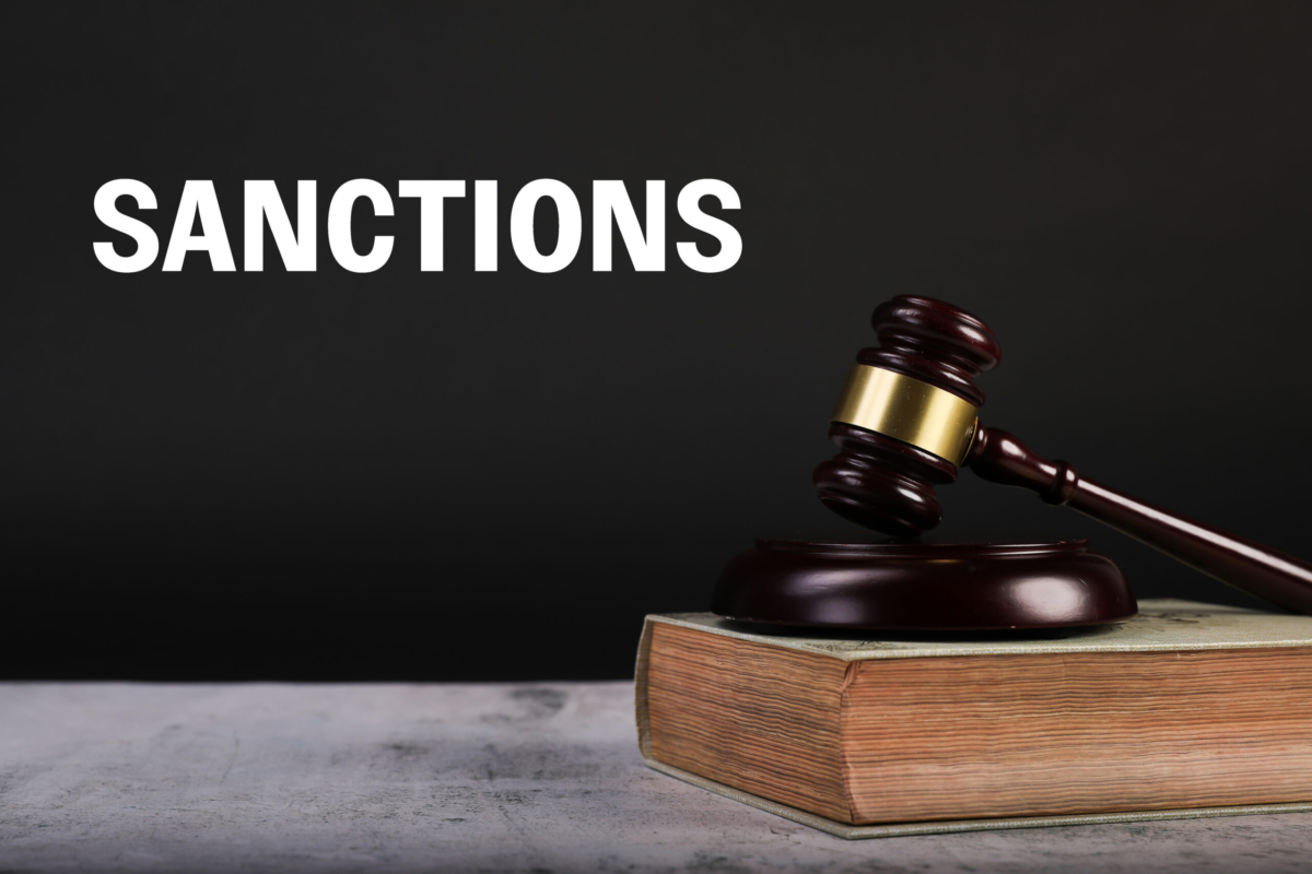 Judge Gavel And Law Books With Sanctions Text