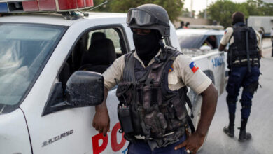 Haitian national policemen guard the entrance to the u.s. embassy as people gather to ask for asylum following the assassination of president jovenel moise